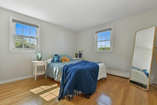 8 Edwards Rd Unit 8A, Woburn, MA 01801 - bedroom with a baseboard heating unit, wood finished floors, and baseboards