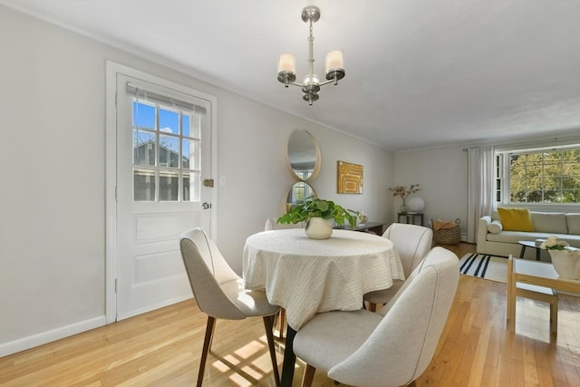 8 Edwards Rd Unit 8A, Woburn, MA 01801 - dining space featuring healthy amount of natural light, light wood-style floors, ornamental molding, a chandelier, and baseboards