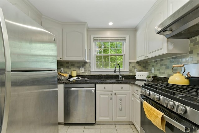 8 Edwards Rd Unit 8A, Woburn, MA 01801 - kitchen with stainless steel appliances, a sink, under cabinet range hood, light tile patterned flooring, and white cabinets