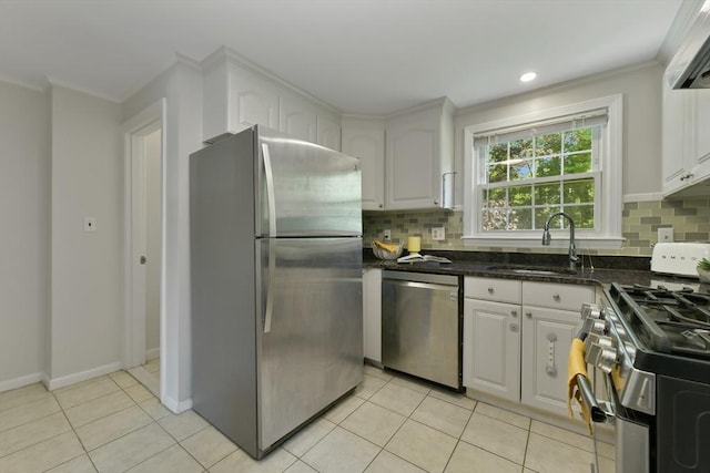 8 Edwards Rd Unit 8A, Woburn, MA 01801 - kitchen with stainless steel appliances, a sink, white cabinets, decorative backsplash, and ornamental molding