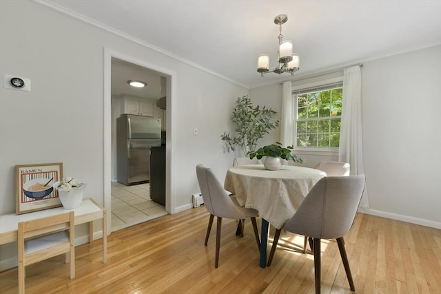 8 Edwards Rd Unit 8A, Woburn, MA 01801 - dining room featuring ornamental molding, a chandelier, light wood-type flooring, baseboards, and a baseboard heating unit
