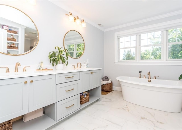 17 Elinor Cir, Waltham, MA 02452 - bathroom with double vanity, marble look tiles, healthy amount of natural light, a freestanding tub, and crown molding