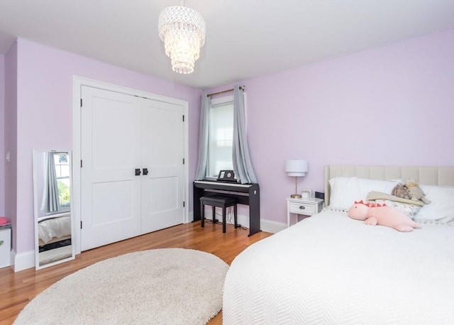 17 Elinor Cir, Waltham, MA 02452 - bedroom with light wood-style floors, a chandelier, and baseboards