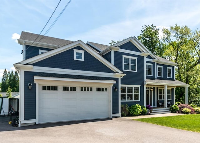 17 Elinor Cir, Waltham, MA 02452 - view of front of property with asphalt driveway, a porch, and a garage
