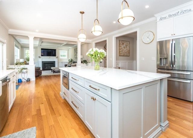 17 Elinor Cir, Waltham, MA 02452 - kitchen with stainless steel appliances, ornate columns, a glass covered fireplace, coffered ceiling, and crown molding