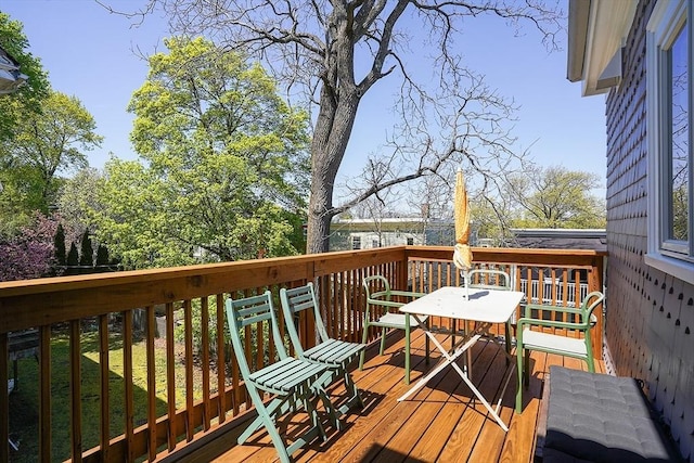 wooden deck featuring outdoor dining space