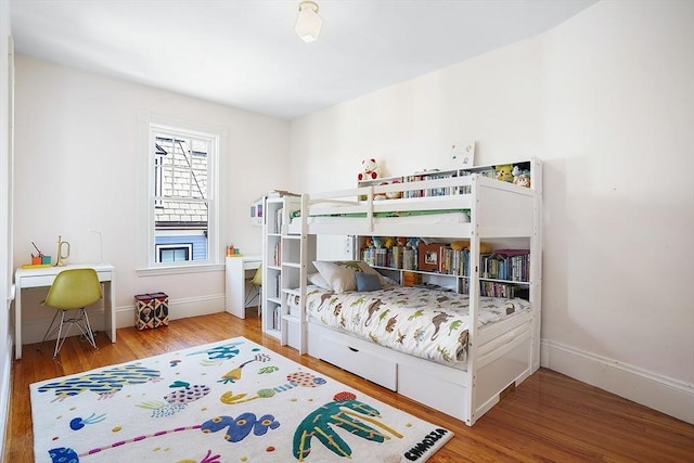 bedroom featuring baseboards and wood finished floors