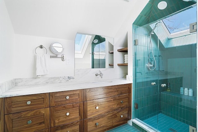 bathroom featuring vanity, a skylight, and a stall shower