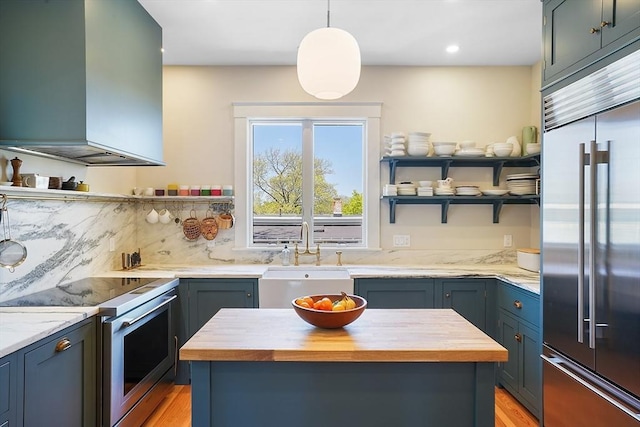 kitchen featuring open shelves, white range with electric stovetop, island exhaust hood, a sink, and stainless steel built in refrigerator