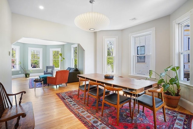dining room with visible vents, light wood finished floors, and a wealth of natural light