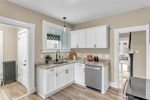 kitchen featuring white cabinetry, stainless steel dishwasher, radiator, and sink