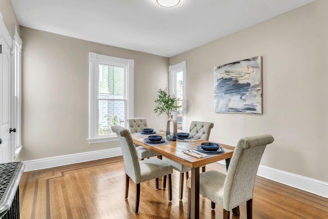 dining space featuring a healthy amount of sunlight and wood-type flooring