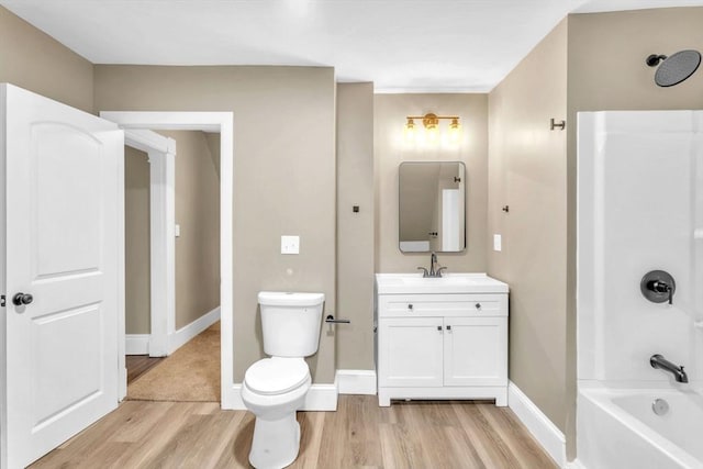 full bathroom with vanity, wood-type flooring, bathtub / shower combination, and toilet