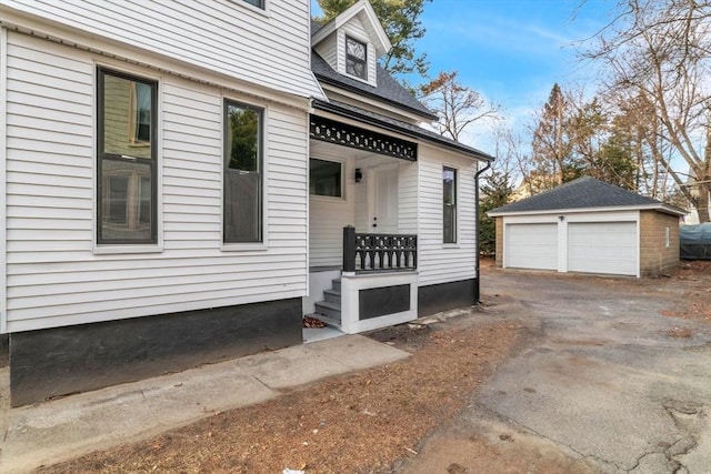 view of side of property with an outbuilding and a garage