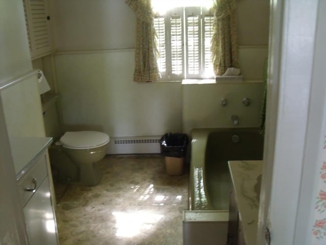 2 N St, Williamsburg, MA 01096 - full bath featuring a baseboard heating unit, toilet, vanity, a bath, and a wainscoted wall