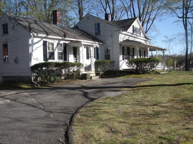 2 N St, Williamsburg, MA 01096 - view of front of home featuring a chimney, a front yard, and a porch