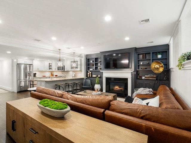 115 Sewall Ave Unit 1, Brookline, MA 02446 - living room featuring a glass covered fireplace, recessed lighting, and crown molding