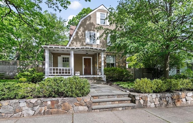 26 Saxon Rd, Newton, MA 02461 - view of front facade with a porch and a gambrel roof