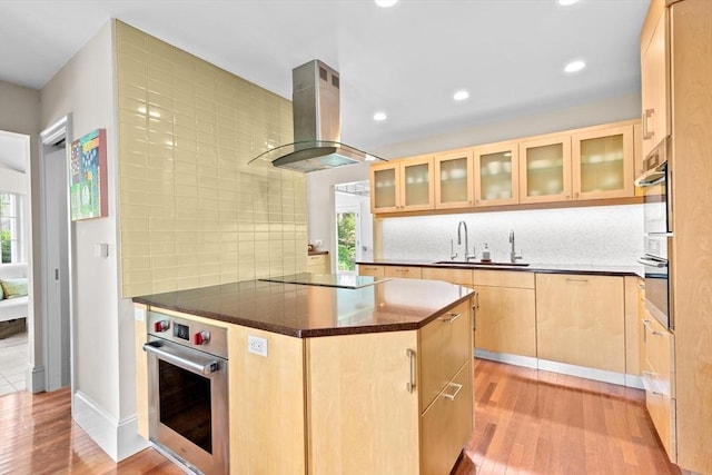 26 Saxon Rd, Newton, MA 02461 - kitchen with island range hood, stainless steel oven, light brown cabinets, a sink, and healthy amount of natural light