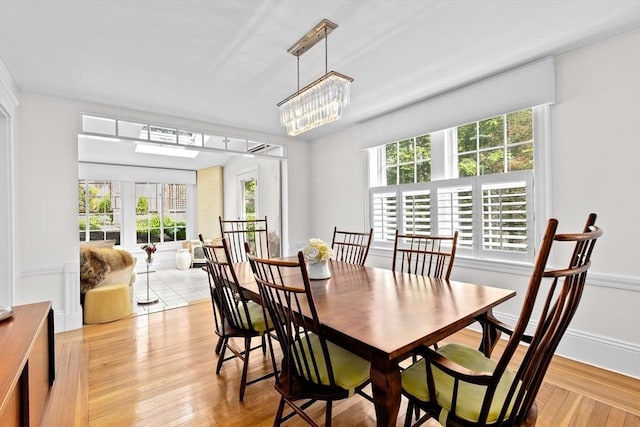 26 Saxon Rd, Newton, MA 02461 - dining area featuring light wood-style flooring and a chandelier
