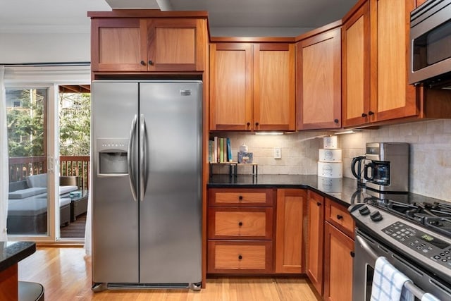 10 Peters Unit 2, Boston, MA 02127 - kitchen featuring stainless steel appliances, brown cabinets, light wood finished floors, and ornamental molding