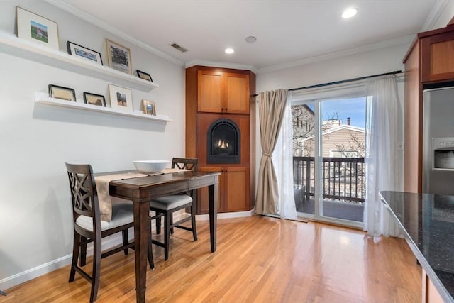 10 Peters Unit 2, Boston, MA 02127 - dining area featuring crown molding, light wood-type flooring, recessed lighting, a large fireplace, and baseboards