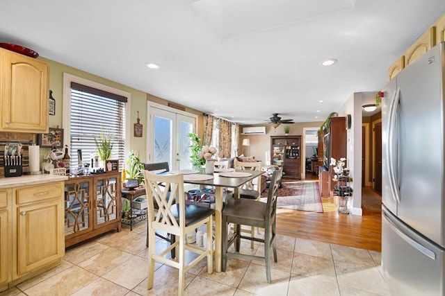 dining room featuring a wall mounted air conditioner, light tile patterned floors, ceiling fan, and french doors