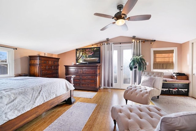 bedroom featuring french doors, lofted ceiling, access to outside, ceiling fan, and light hardwood / wood-style floors