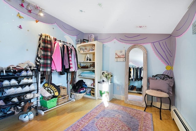 walk in closet featuring a baseboard radiator and light wood-type flooring