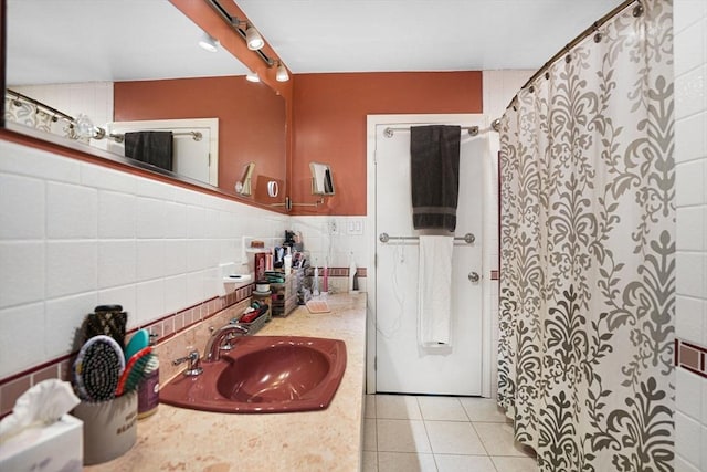 bathroom featuring tile patterned flooring, vanity, and tile walls