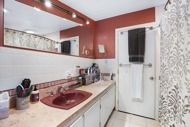 bathroom featuring tile patterned floors, vanity, and tile walls