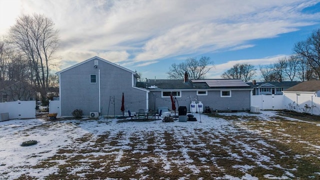 view of snow covered back of property