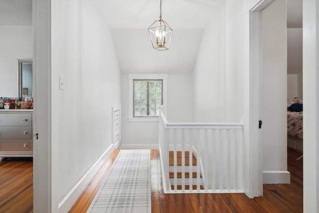139 Washington St, Hudson, MA 01749 - corridor featuring wood finished floors, a chandelier, vaulted ceiling, and baseboards