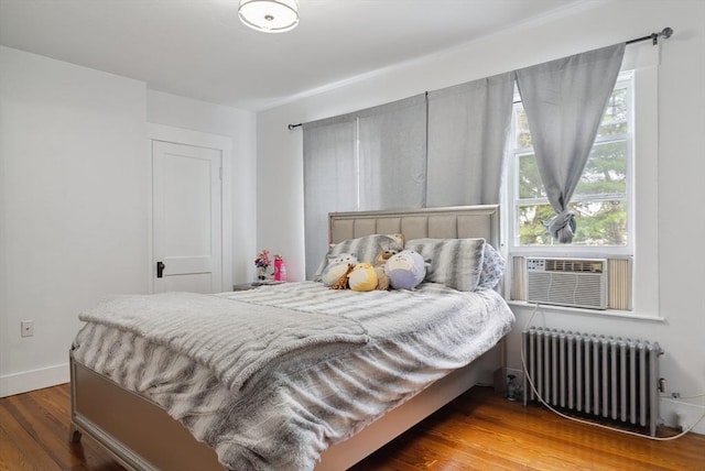 139 Washington St, Hudson, MA 01749 - bedroom with radiator, wood finished floors, baseboards, and cooling unit