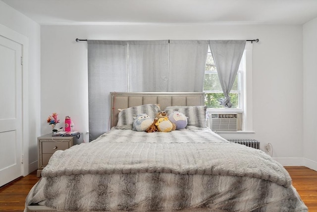 139 Washington St, Hudson, MA 01749 - bedroom with wood finished floors, cooling unit, radiator, and baseboards