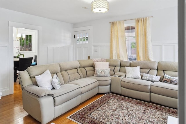139 Washington St, Hudson, MA 01749 - living room featuring wainscoting, light wood-type flooring, and a decorative wall