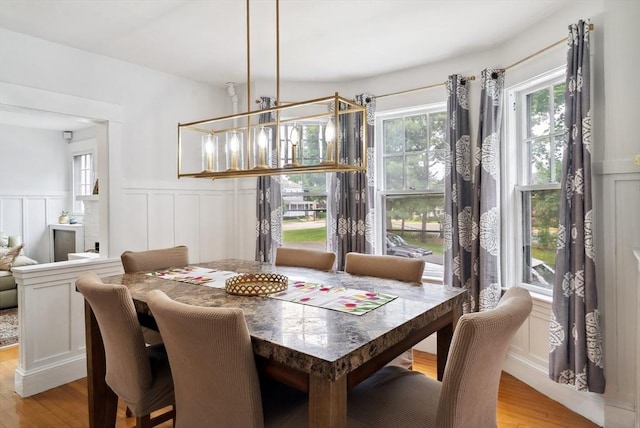 139 Washington St, Hudson, MA 01749 - dining space with a decorative wall, light wood finished floors, and wainscoting