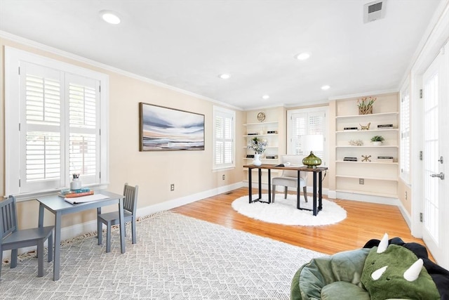 office space with crown molding, recessed lighting, baseboards, light wood-type flooring, and visible vents