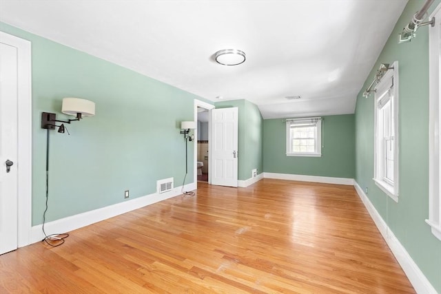 unfurnished bedroom featuring baseboards, visible vents, and light wood-style floors