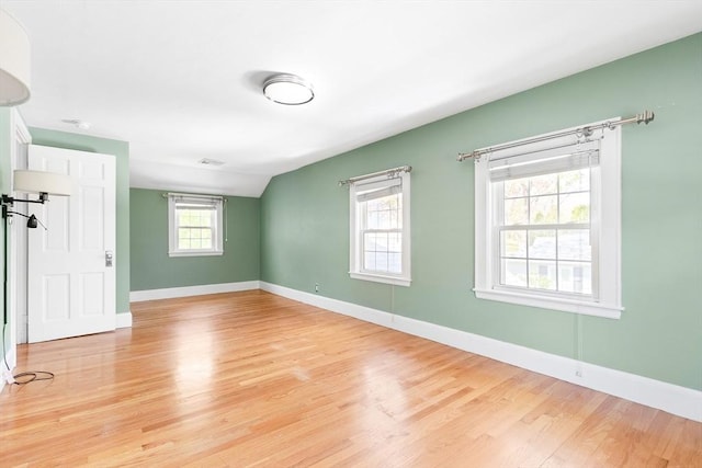 empty room with baseboards and light wood-style flooring