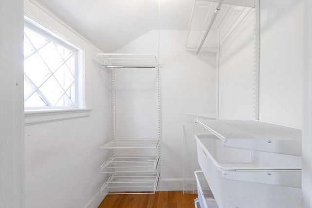 spacious closet featuring wood finished floors and lofted ceiling
