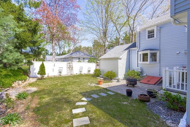 view of yard with fence, a patio, and an outdoor fire pit