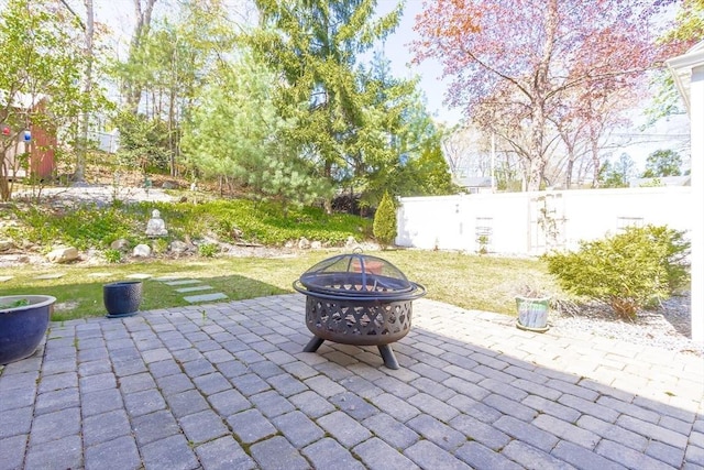 view of patio featuring a fire pit and fence