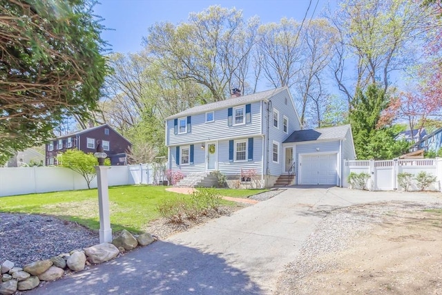 colonial-style house with driveway, a chimney, a garage, fence, and a front lawn