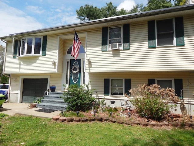 13 Lark St, New Bedford, MA 02745 - split foyer home featuring cooling unit, an attached garage, and driveway