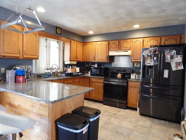 13 Lark St, New Bedford, MA 02745 - kitchen with a peninsula, dark stone countertops, a sink, black appliances, and under cabinet range hood