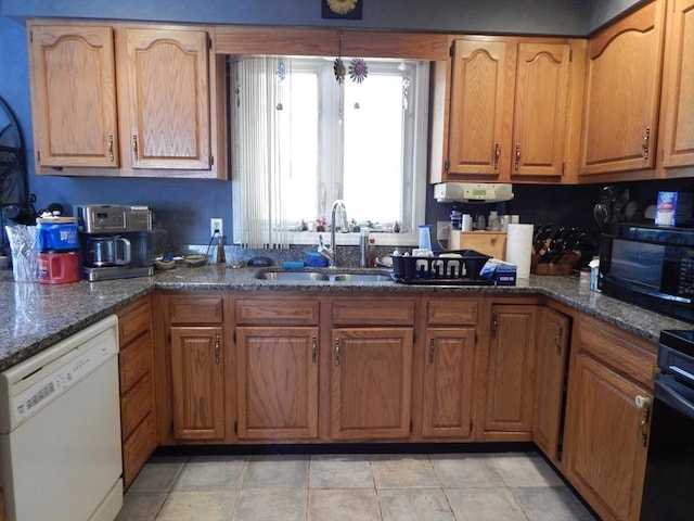 13 Lark St, New Bedford, MA 02745 - kitchen with white dishwasher, a sink, black microwave, dark stone countertops, and brown cabinets