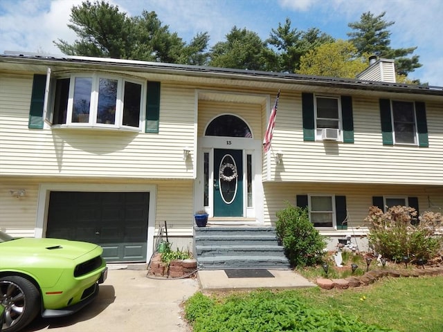 13 Lark St, New Bedford, MA 02745 - raised ranch with an attached garage, driveway, and a chimney
