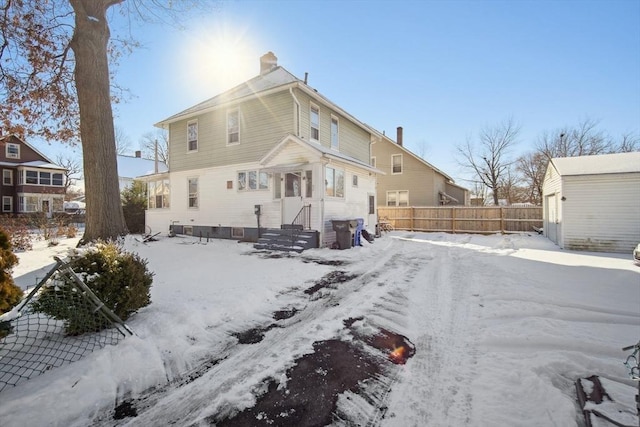 snow covered property featuring a garage