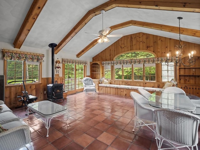 47 Skelton Rd, Burlington, MA 01803 - living room with a wood stove, wooden walls, plenty of natural light, wainscoting, and a chandelier